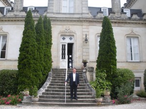Zhang stands on the steps of his Chateau Grand Moueys