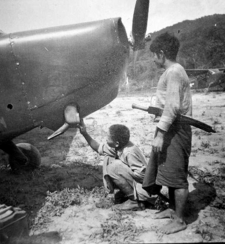  Two boys in northeast India have a look at an American observation plane 